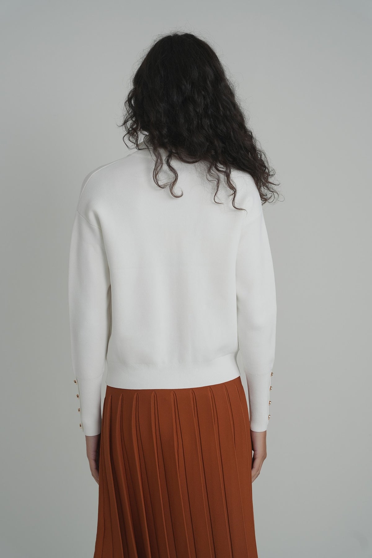 Pleated Wonder Skirt in Pumpkin – on model – ALEEZA PARIS