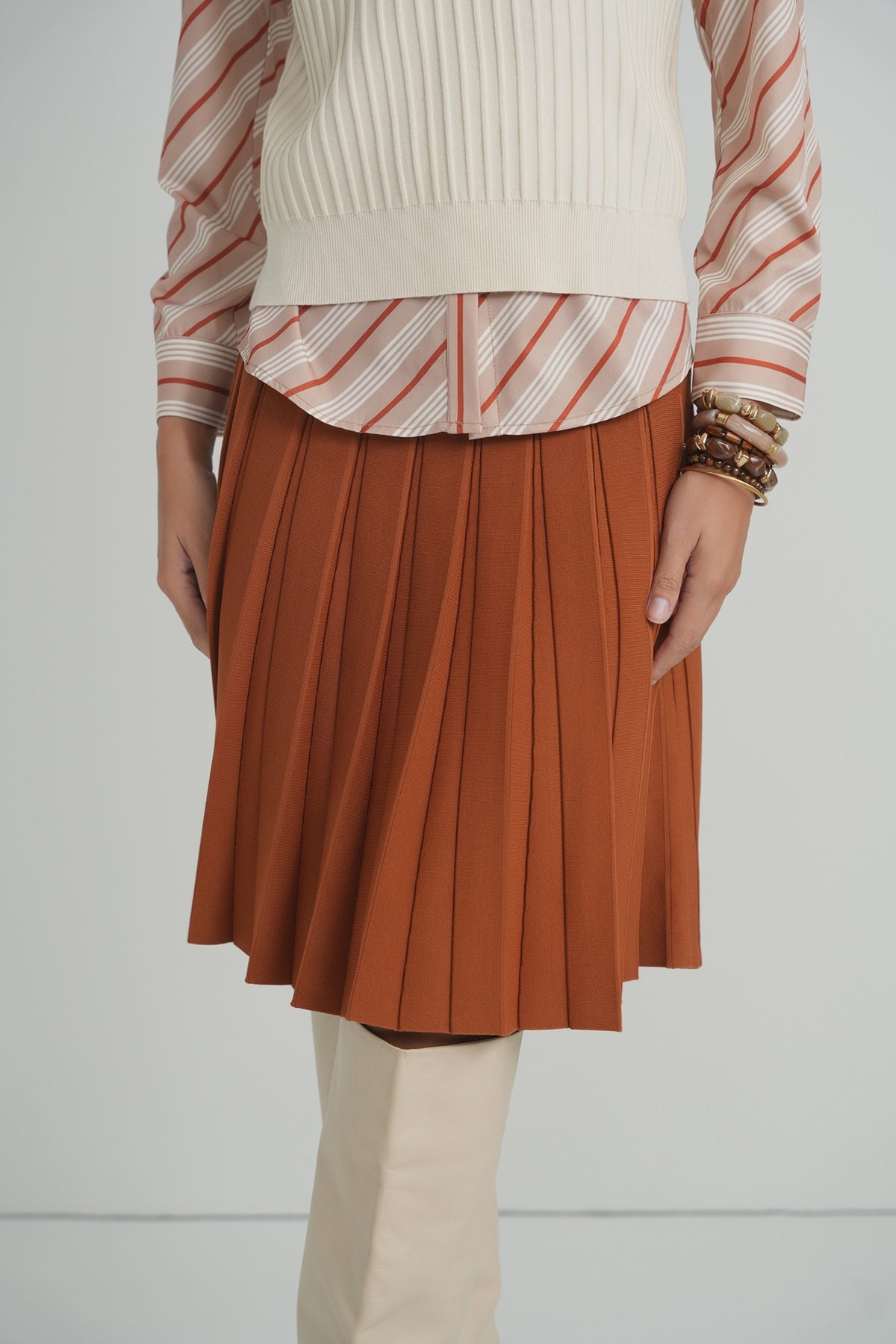 Pleated Wonder Skirt in Pumpkin – on model – ALEEZA PARIS