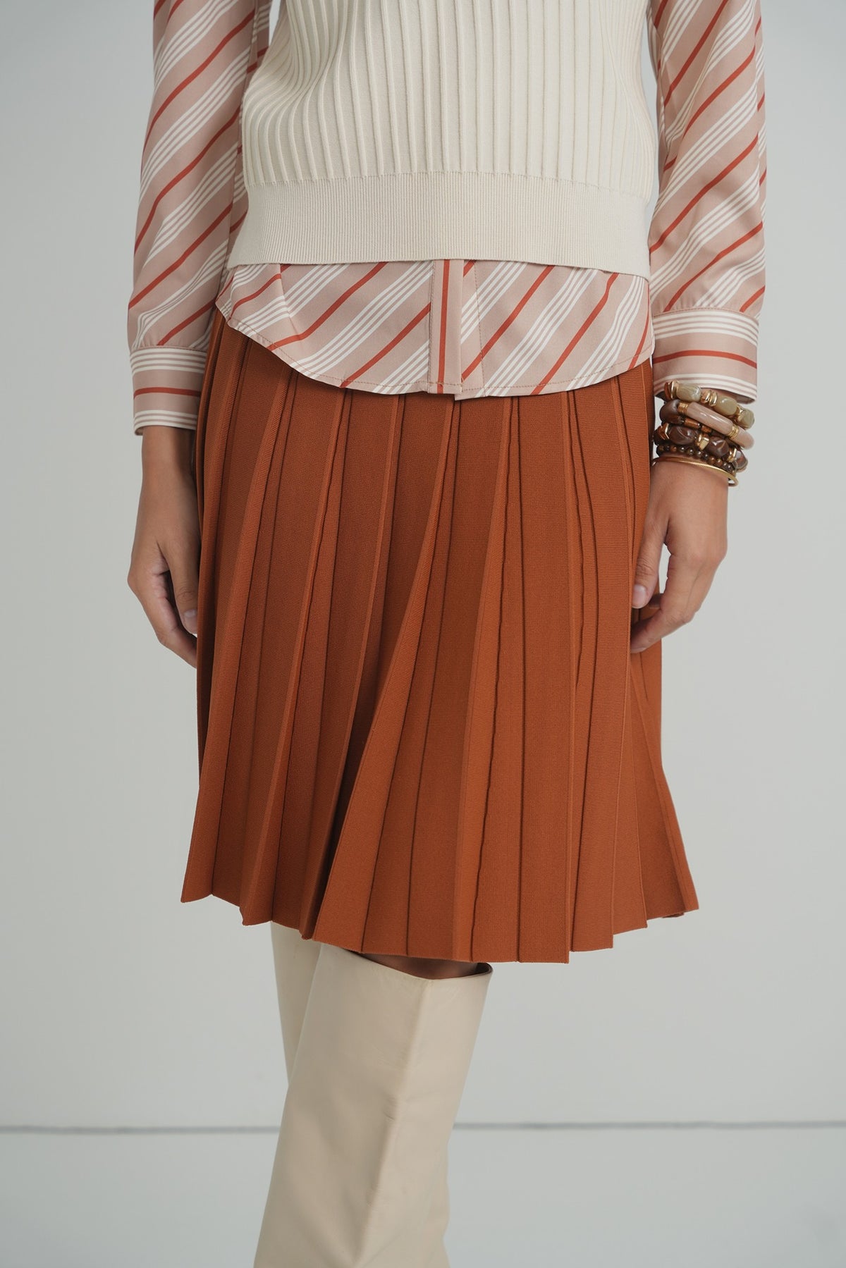 Pleated Wonder Skirt in Pumpkin – on model – ALEEZA PARIS
